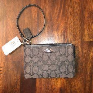 Black pattern Coach wristlet